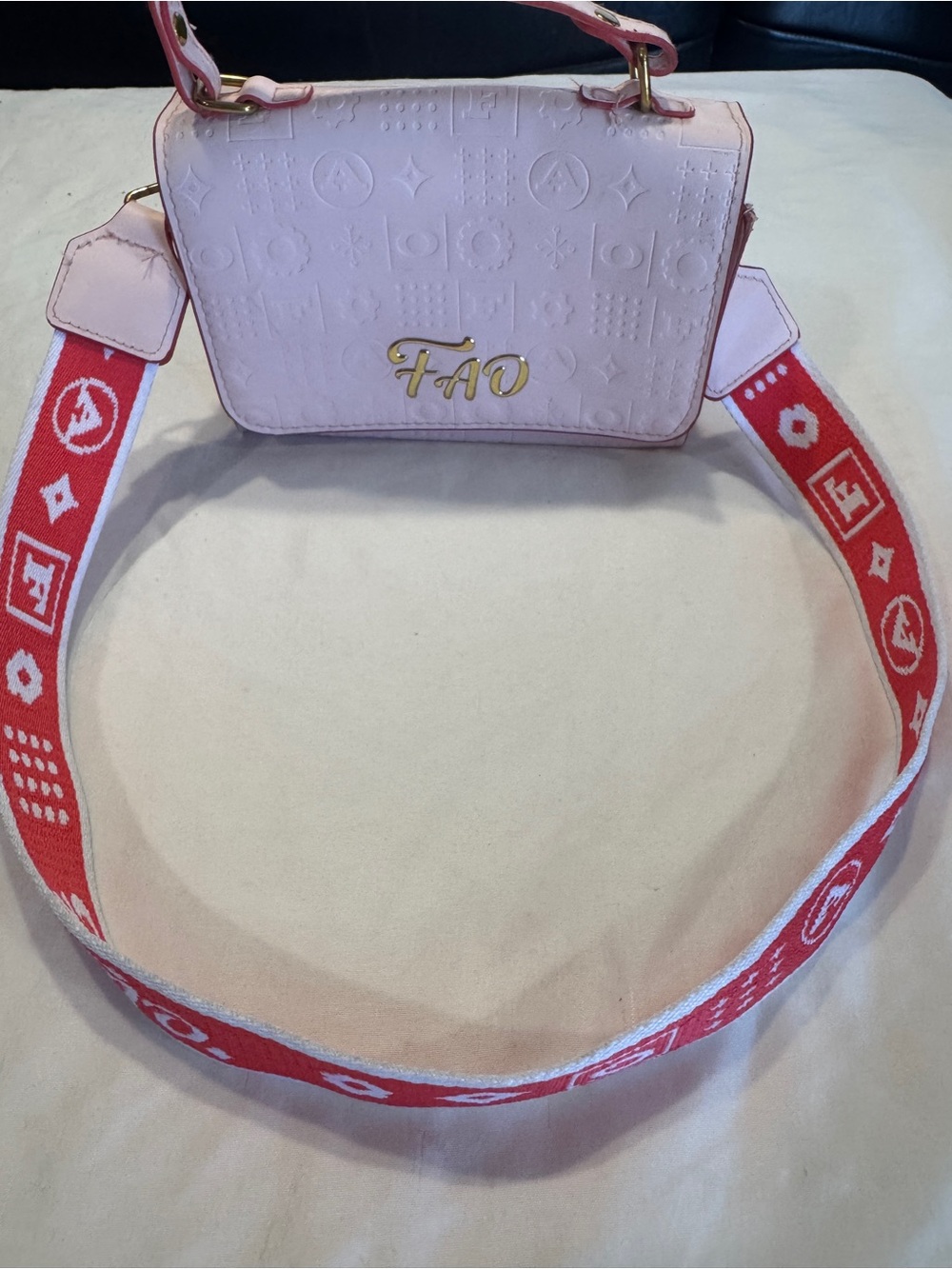Pink Embossed Crossbody Bag with Red Jacquard Strap